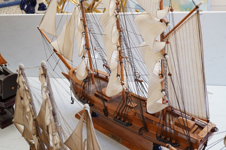 A collection of ten wooden models of famous ships including; the Cutty Sark, HMS Victory, the Mayflower, Revenge, and Santa Maria, largest 125cm wide